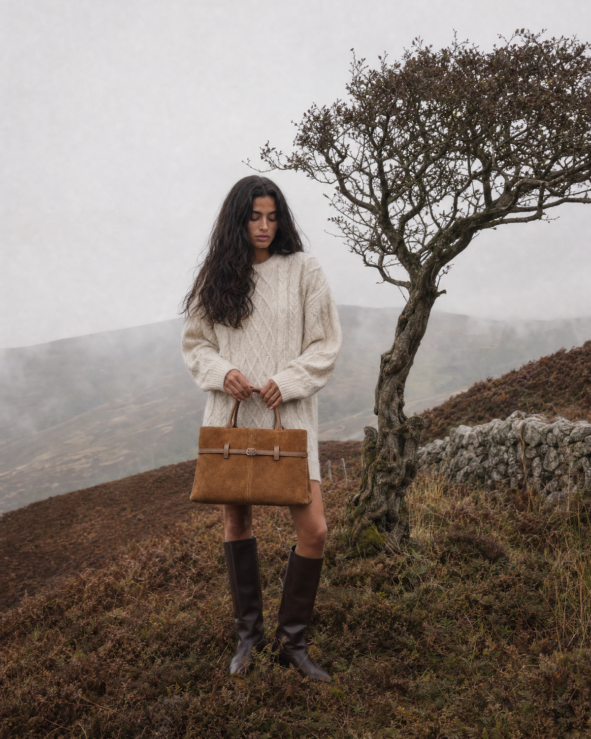 Woman on a misty autumn moor with The Brume Belted Tote in Tabac