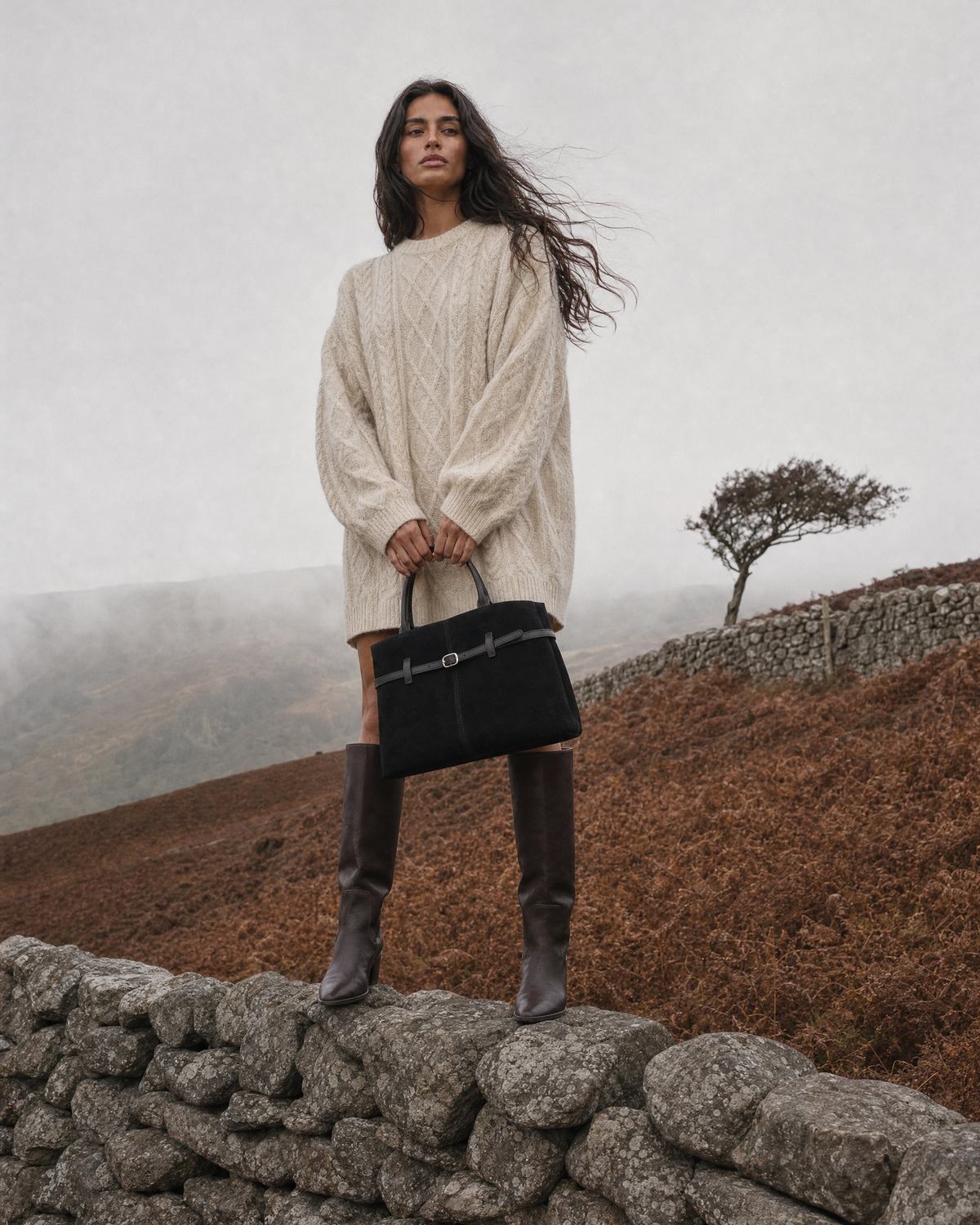 Woman on a misty autumn moor with The Brume Belted Tote in Noir