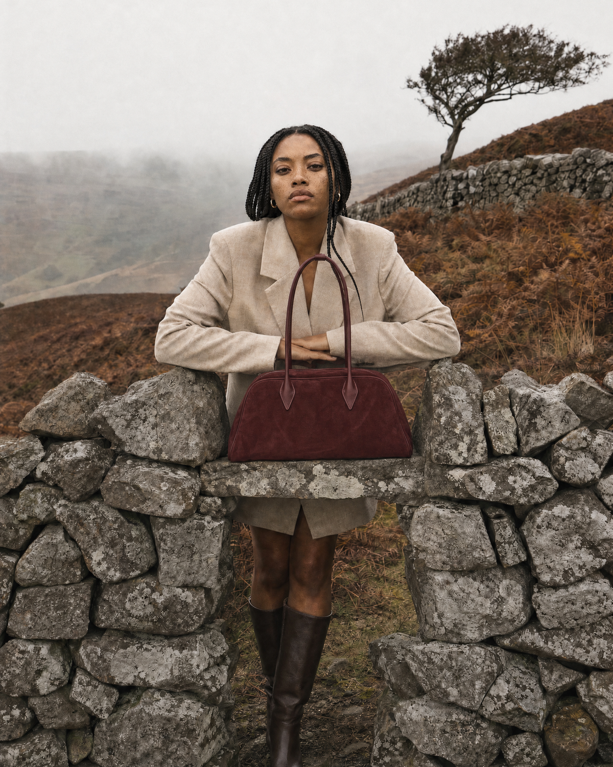 Woman leaning on a dry-stone wall with The Brume East-West in Bordeaux