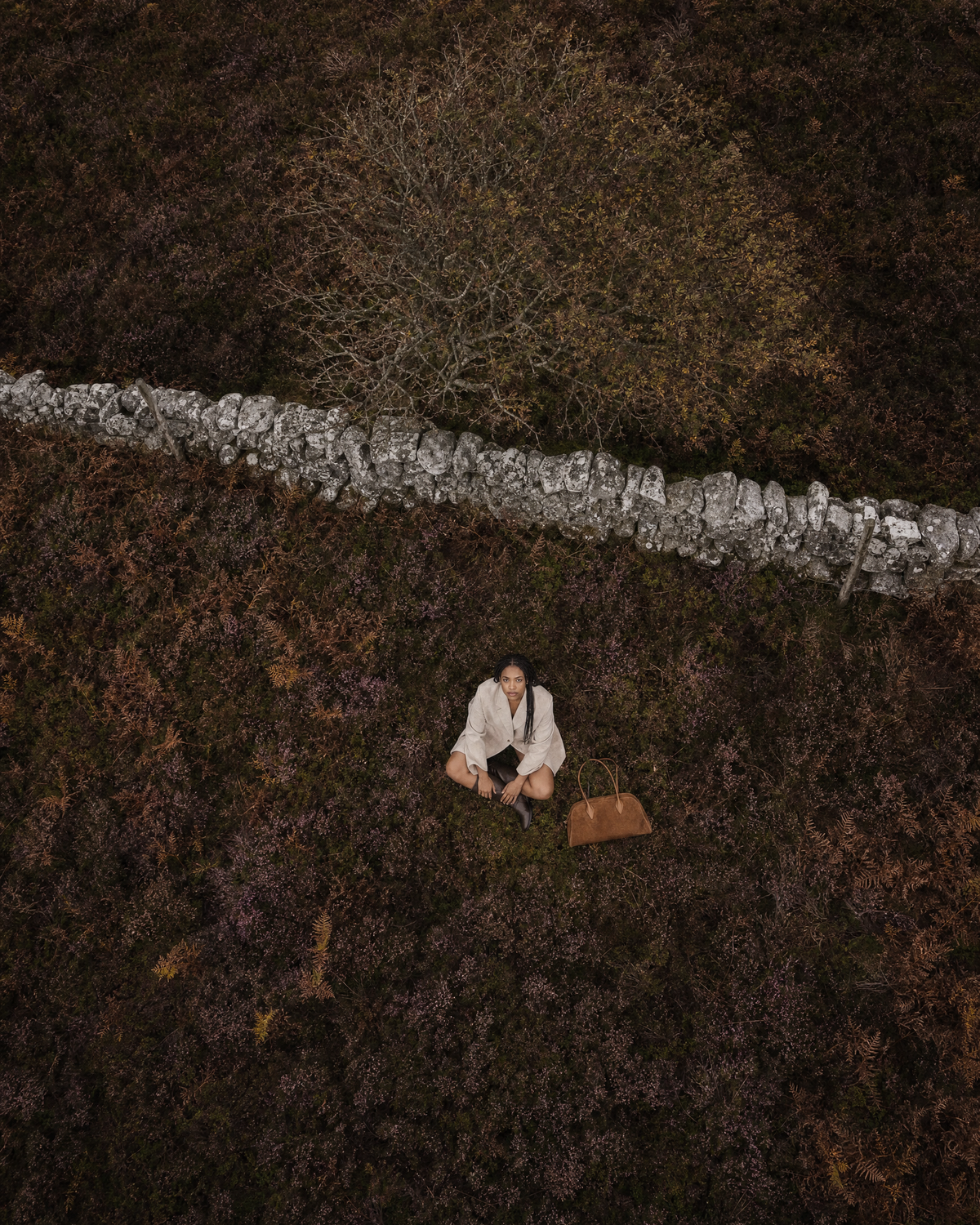 Aerial view of a woman in the heather with The Brume East-West in Tabac