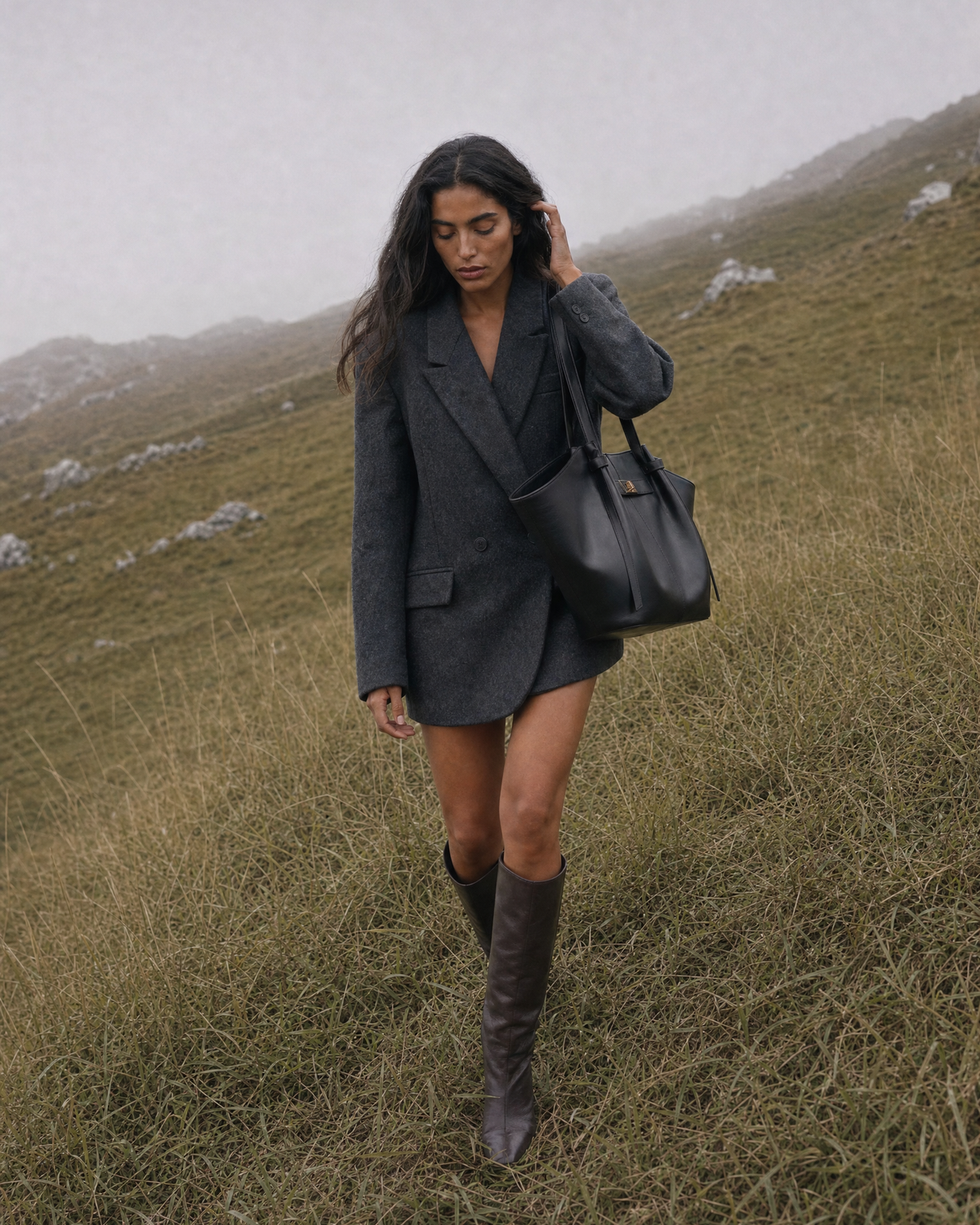 Woman on a misty hillside with The Aurore Wing in Noir