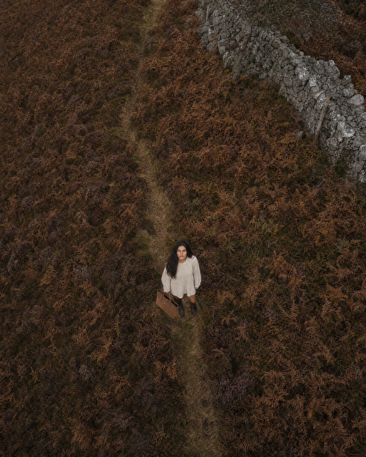 Wide view of a misty moor with The Brume Belted Tote in Tabac