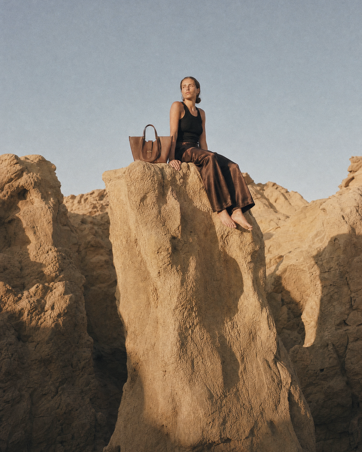 Woman walking through a sandstone gorge with The Havre Buckle in Espresso