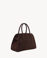 The Aurore Suede Satchel in Espresso, three-quarter view with side buckle