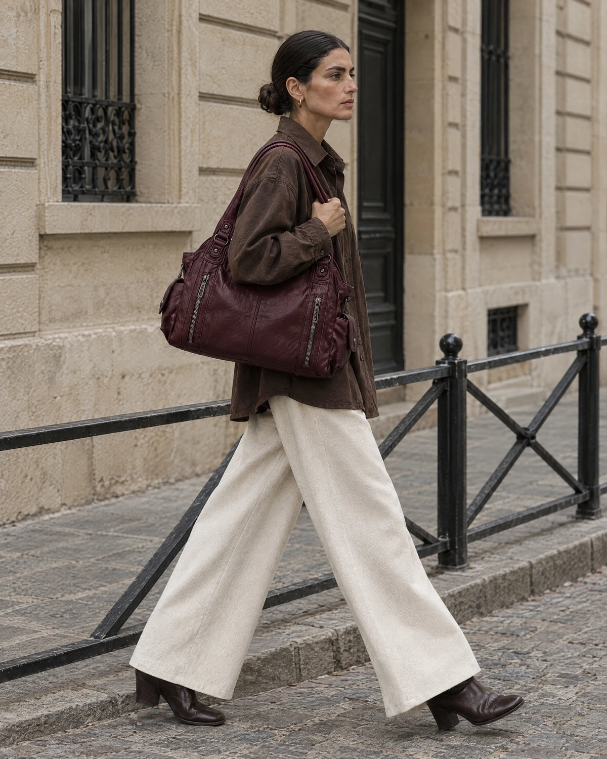 The Estran in Bordeaux, worn on the shoulder on a quiet stone street