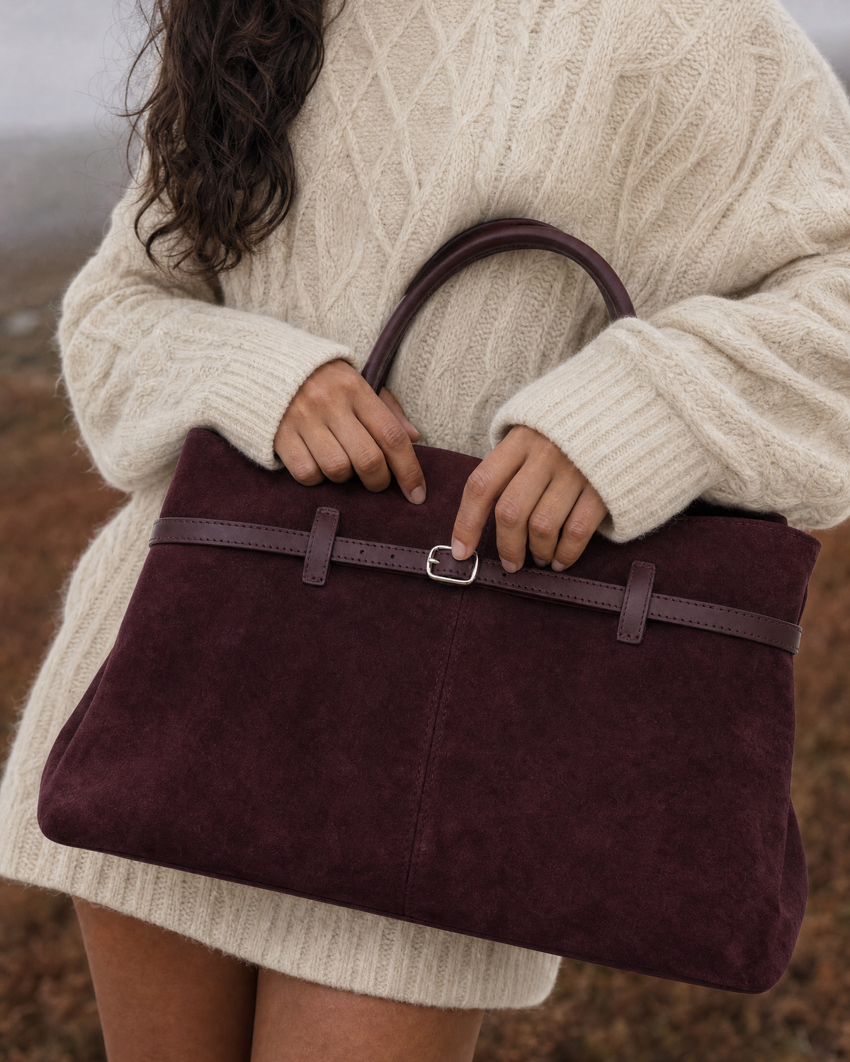 Detail of The Brume Belted Tote in Bordeaux on a misty moor