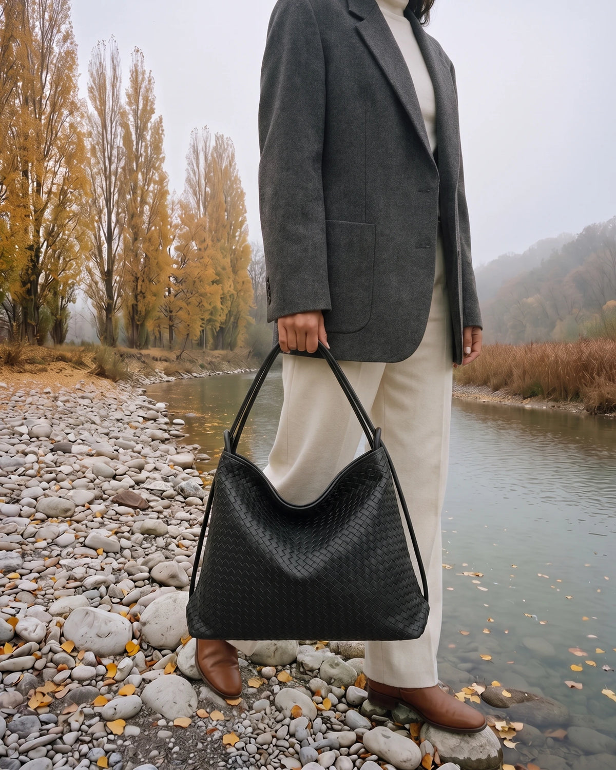 The Embellie Grand in Noir Mat, large woven leather tote carried by the double cord handle