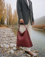 The Embellie in Bordeaux, woven leather tote carried by the double cord handle