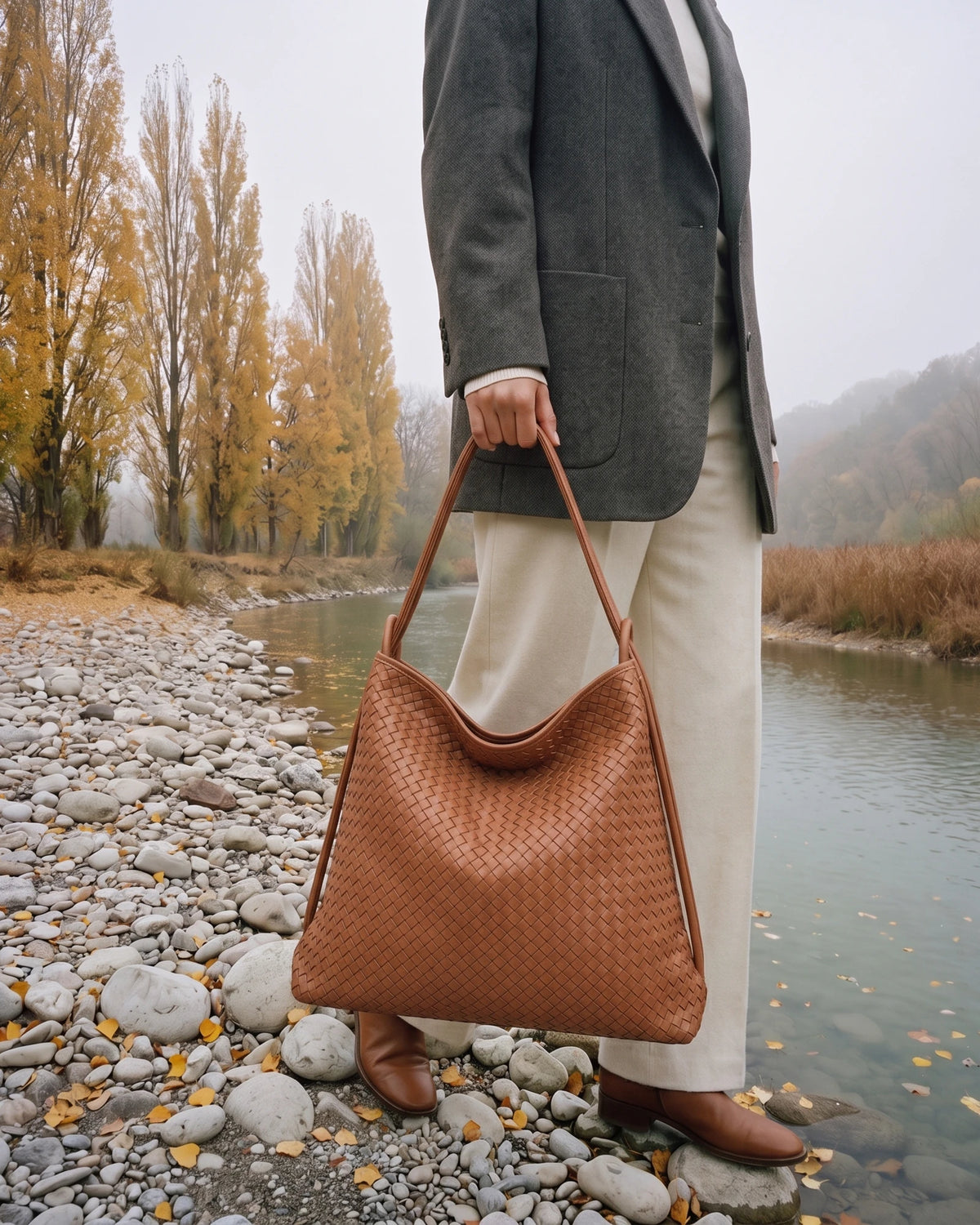 The Embellie Grand in Caramel, large woven leather tote carried by the double cord handle