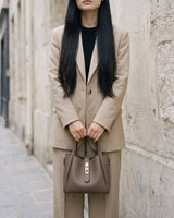 The Grève in Taupe held in both hands by its top handles