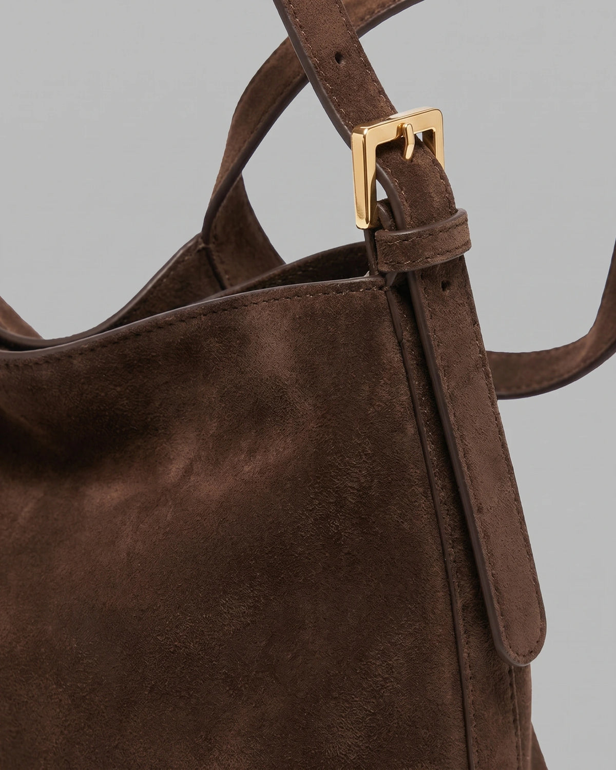 Close-up of the suede strap and gold buckle on The Houle Petite Suede in Chocolate
