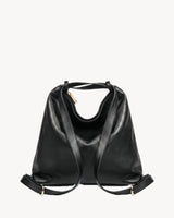 The Jusant Carryall in Noir, worn as a backpack, strap arrangement