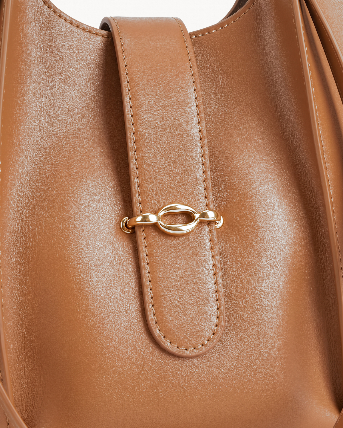Close-up of the gold link on the front tab of The Havre Buckle in Cognac