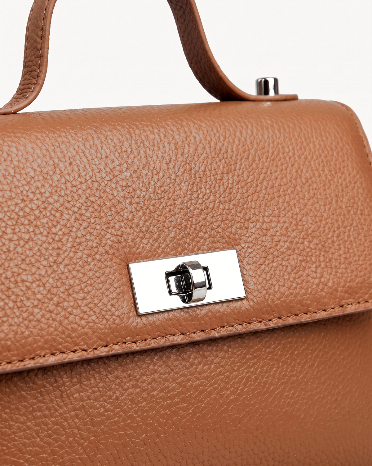 Close-up of the silver turn-lock on The Brise in Cognac