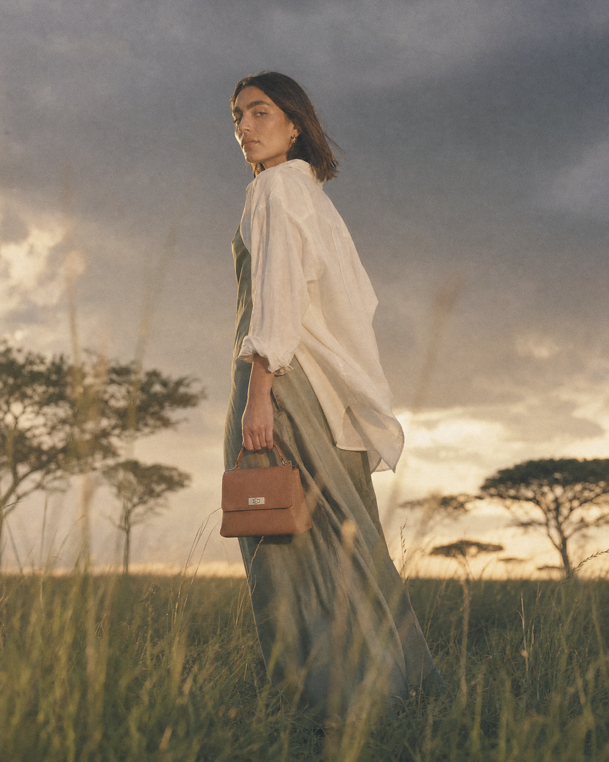Woman standing in tall grass holding The Brise in Cognac