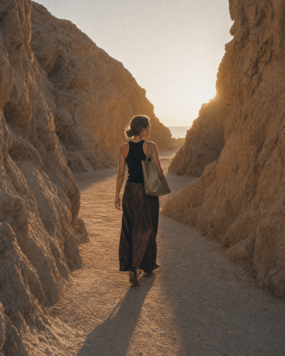 Woman walking toward the sun wearing The Havre Buckle in Olive