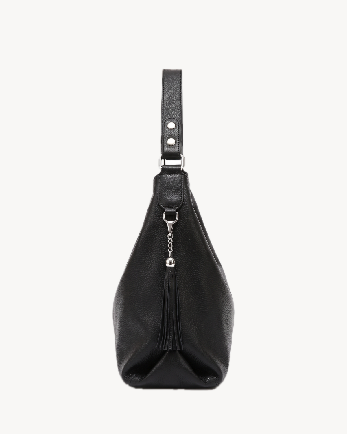 The Houle Soft in Noir, black pebbled leather hobo bag, side view with leather tassel