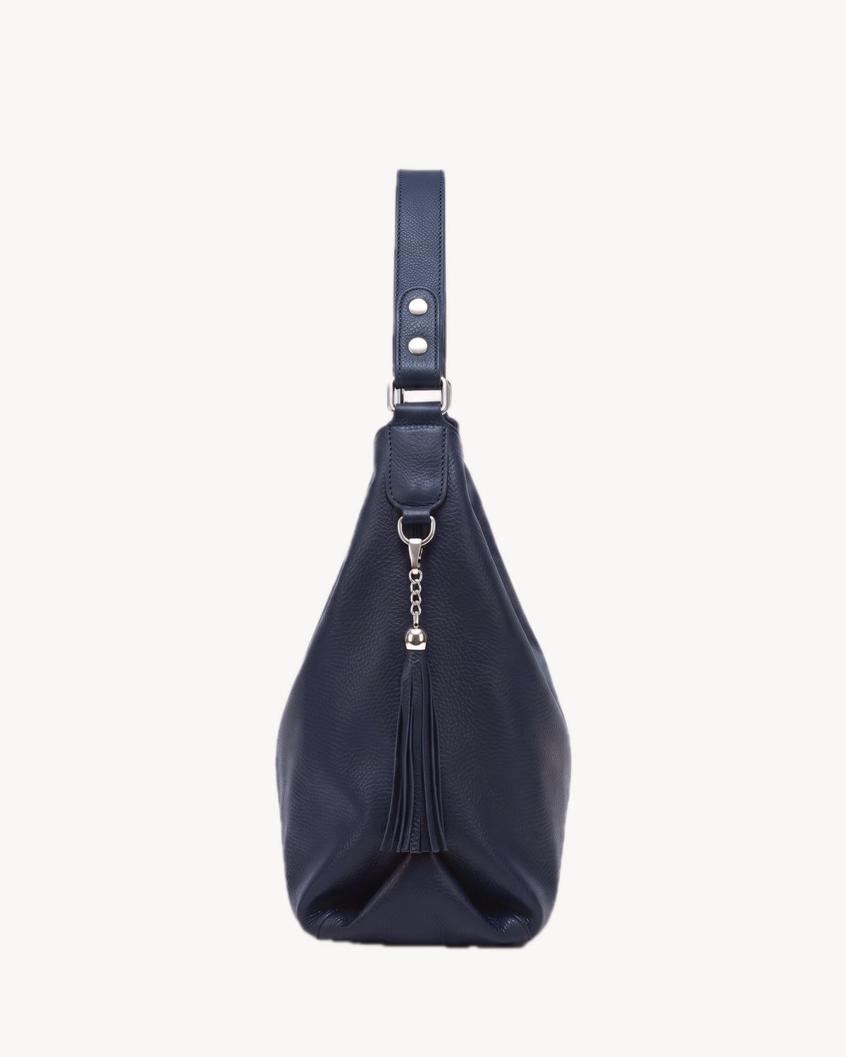 The Houle Soft in Nuit, midnight navy grained leather hobo bag, side view with leather tassel