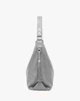 The Houle Soft in Galet, pebble grey pebbled leather hobo bag, side view with leather tassel