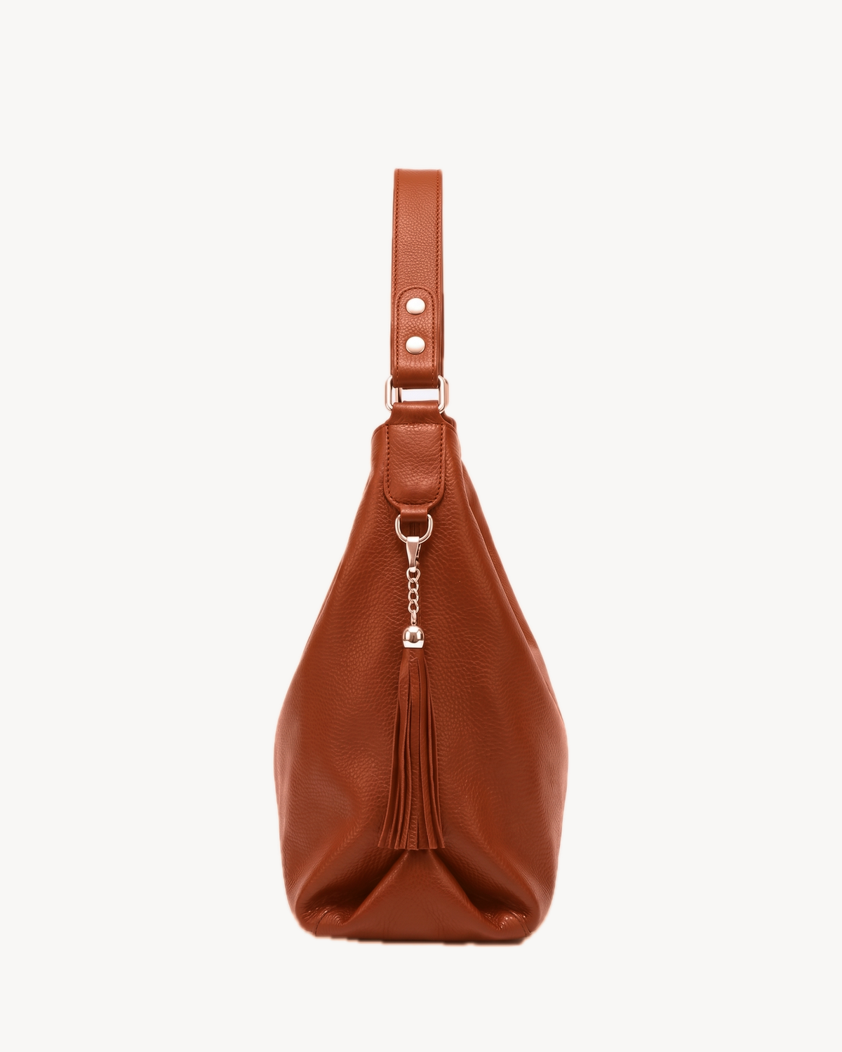 The Houle Soft in Cognac, cognac brown pebbled leather hobo bag, side view with leather tassel