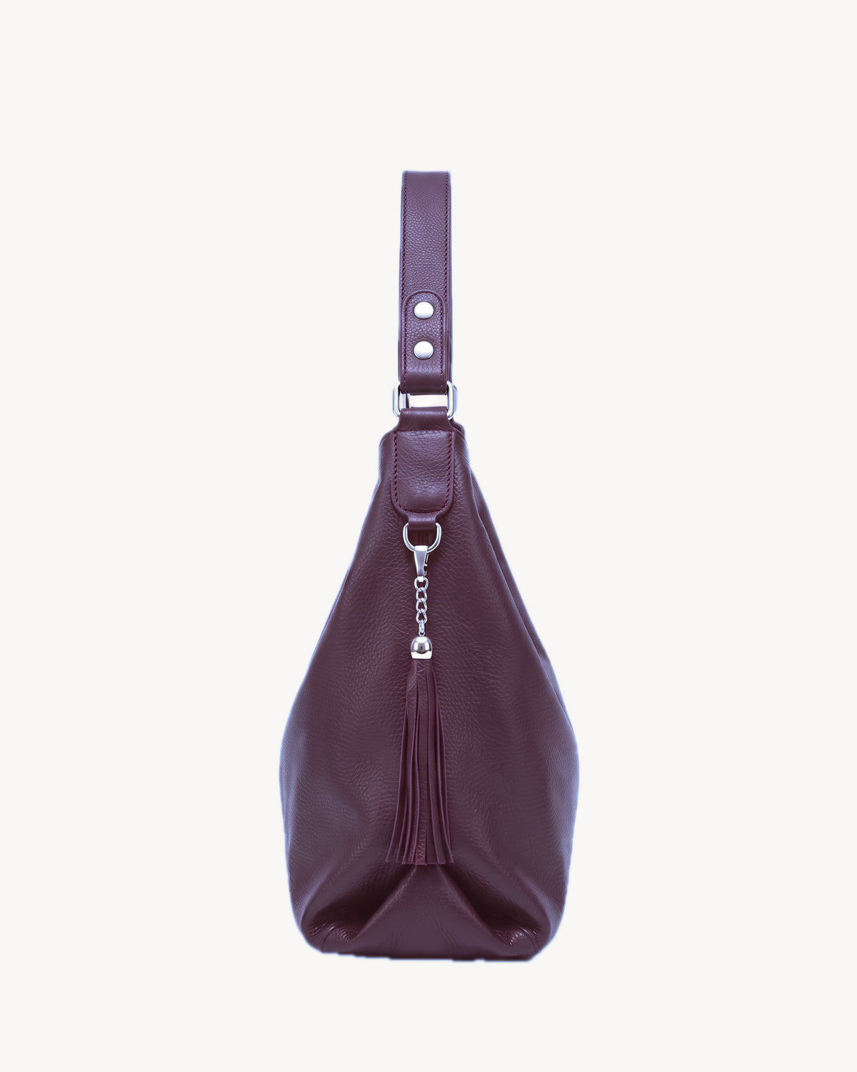 The Houle Soft in Prune, plum pebbled leather hobo bag, side view with leather tassel