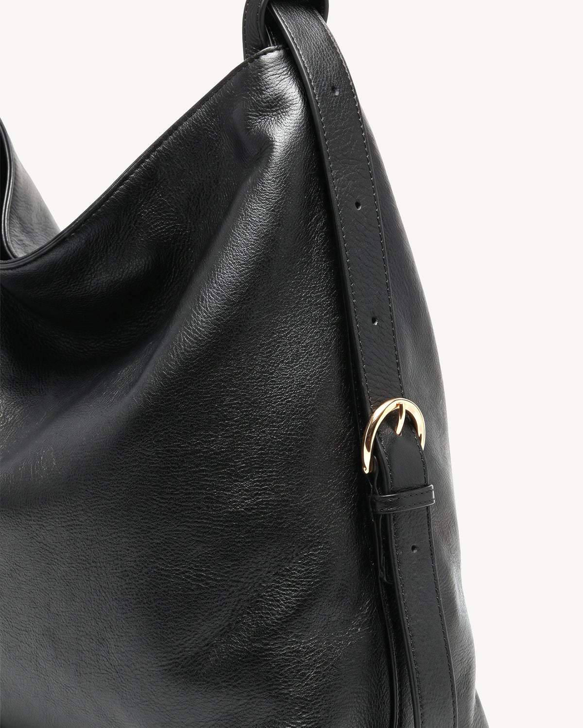 The Jusant Carryall in Noir, gold buckle and strap detail