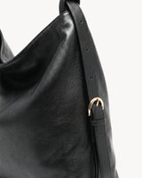 The Jusant Carryall in Noir, gold buckle and strap detail