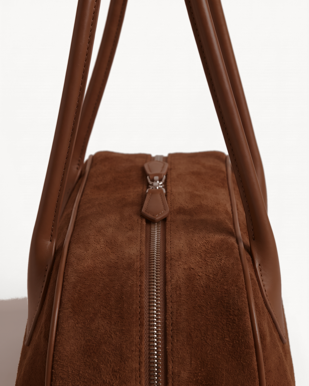 Close-up of the zip and handles of The Brume East-West in Chocolate