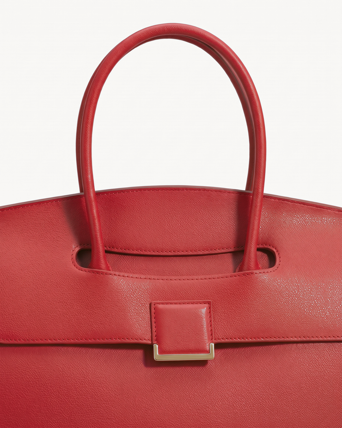 Close-up of the top handle passing through the flap of The Aurore Briefcase in Rouge