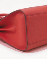 Close-up of the pebbled side gusset of The Aurore Briefcase in Rouge