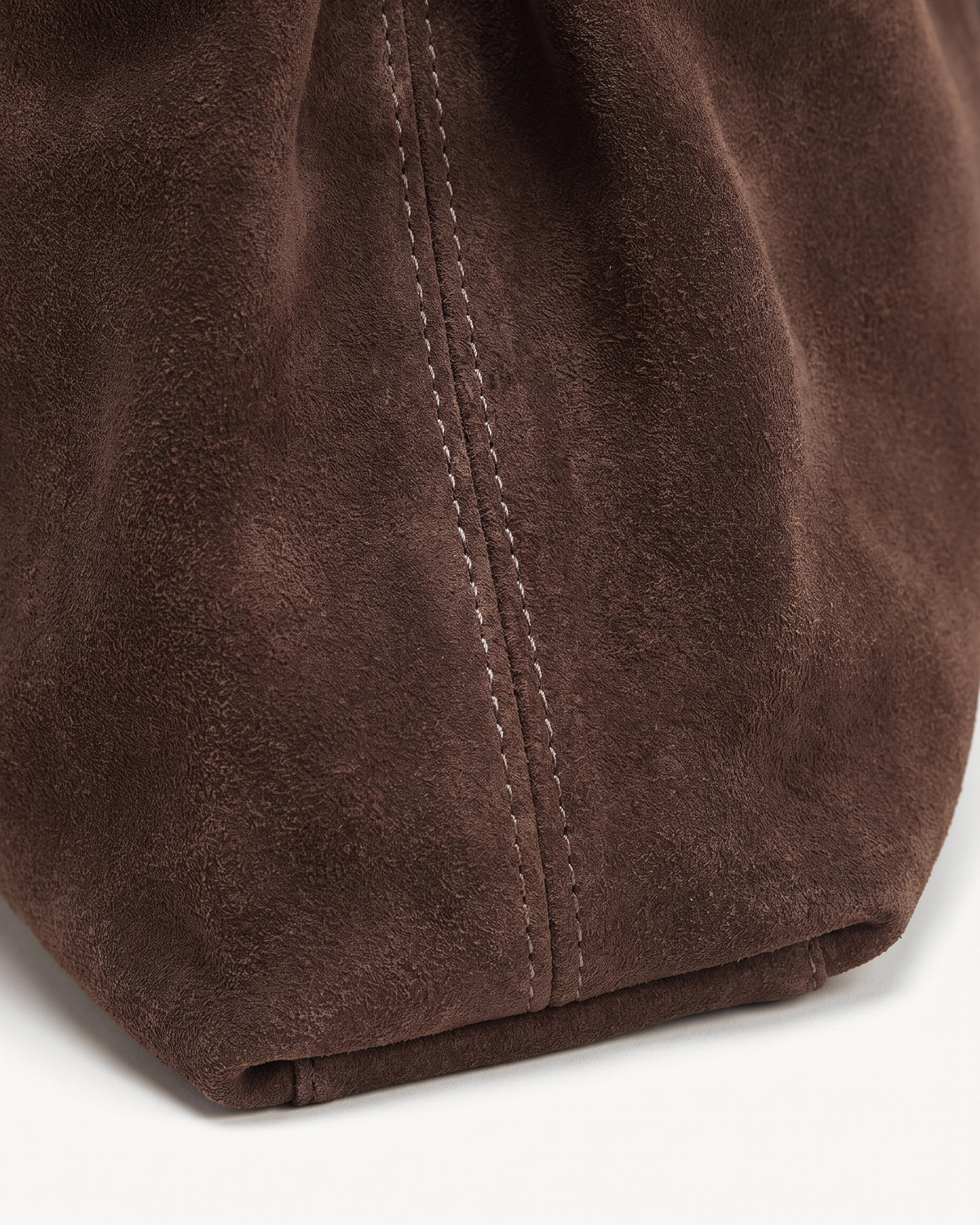 Close-up of the chocolate suede nap of The Brume Belted Tote