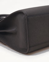 Close-up of the pebbled side gusset of The Aurore Briefcase in Noir