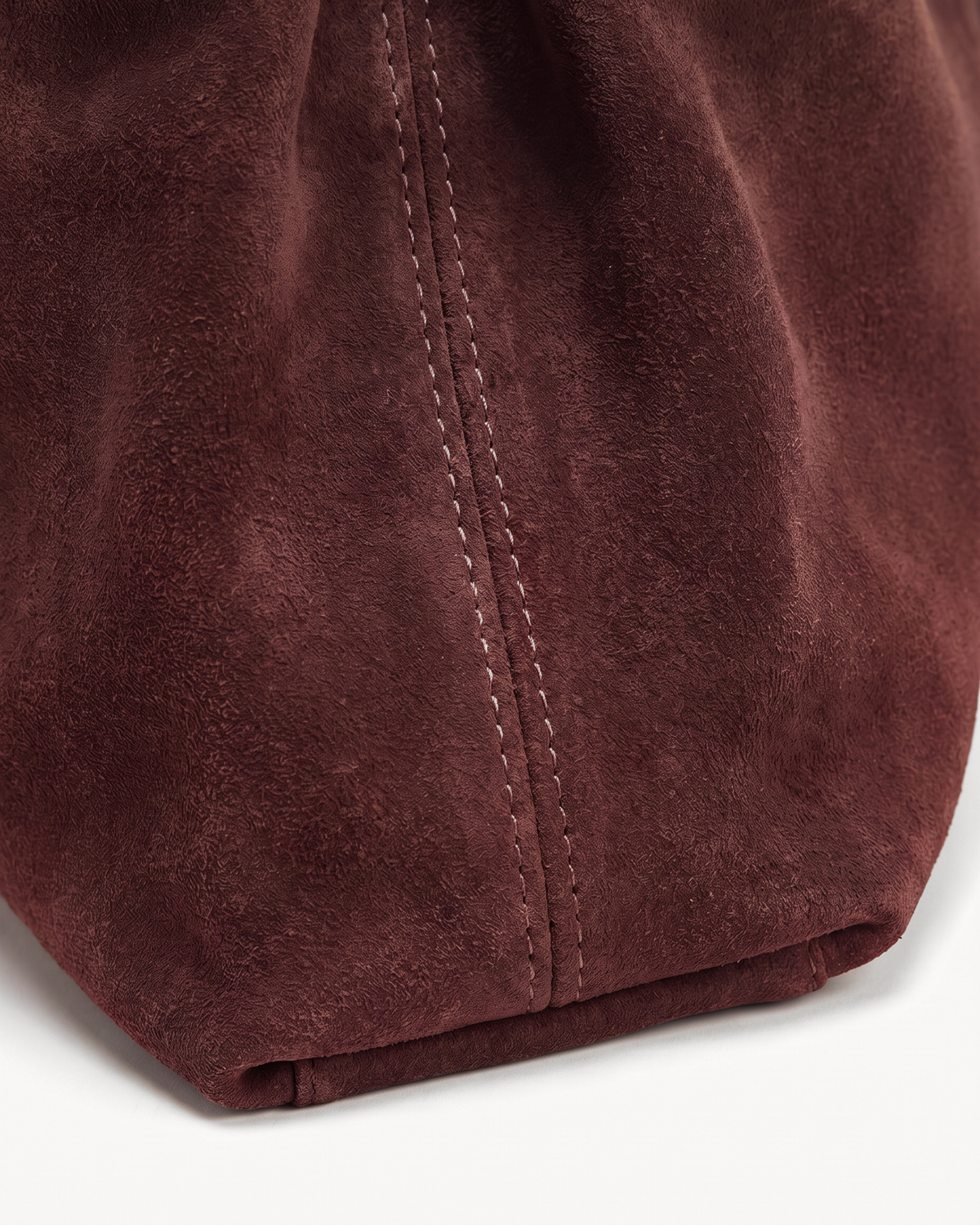 Close-up of the bordeaux suede nap of The Brume Belted Tote