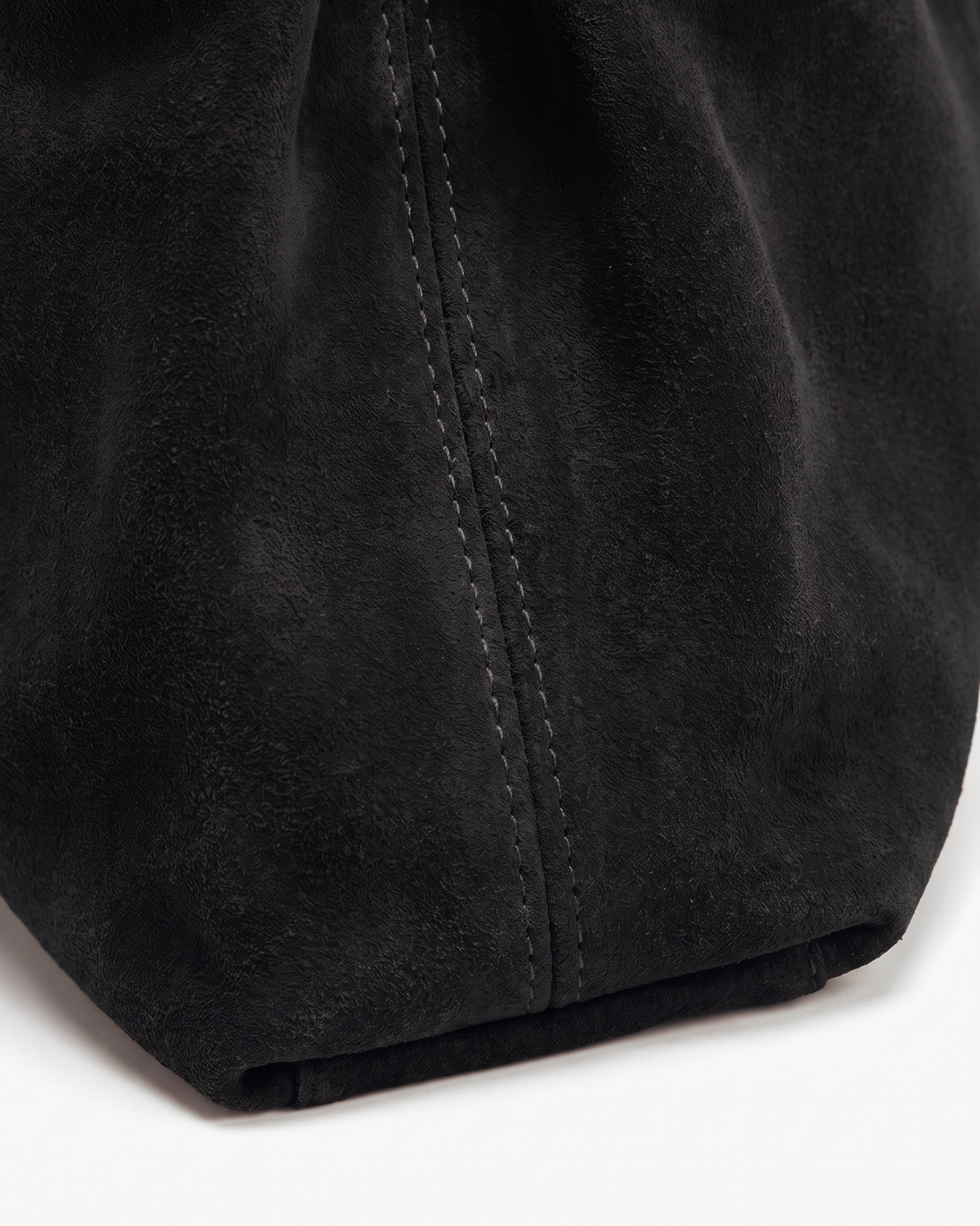 Close-up of the noir suede nap of The Brume Belted Tote