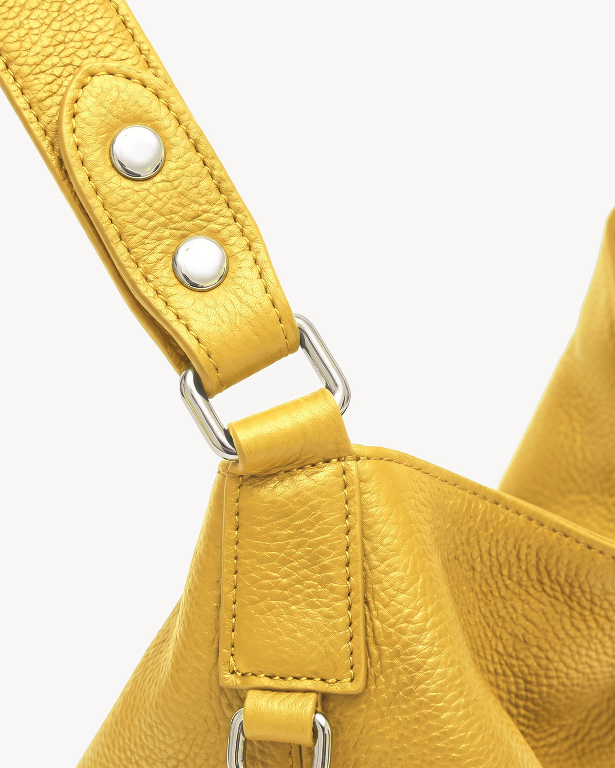The Houle Soft in Citron, close-up of the leather handle with silver press studs and ring