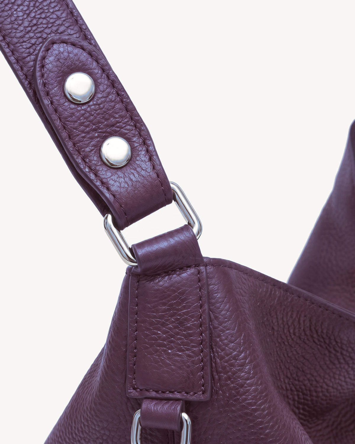 The Houle Soft in Prune, close-up of the leather handle with silver press studs and ring