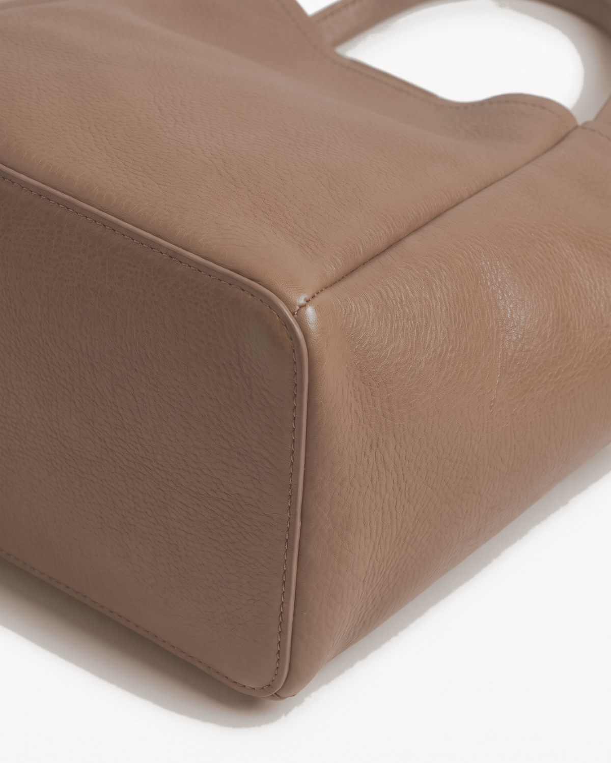 Close-up of the leather and base corner of The Havre Day in Taupe