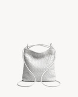 The Embellie Mini in Écru, worn as a backpack: the cords pulled through the loops as shoulder straps