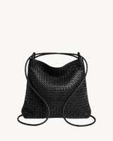 The Embellie Grand in Noir Mat, worn as a backpack: the cords pulled through the loops as shoulder straps