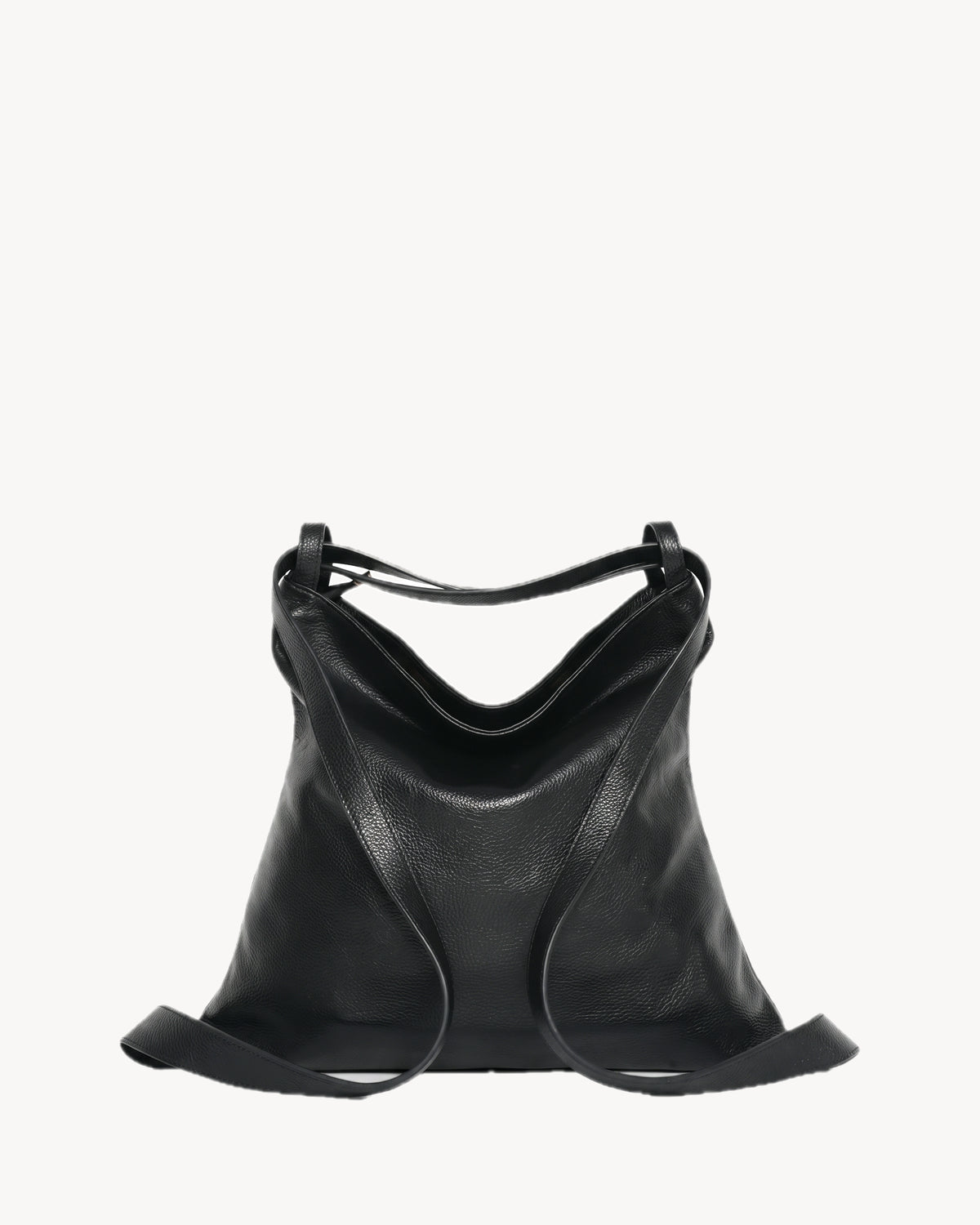 The Embellie Pebbled in Noir, worn as a backpack: the strap runs down both sides as two shoulder straps