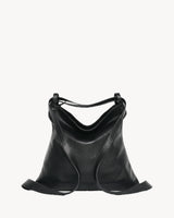 The Embellie Pebbled in Noir, worn as a backpack: the strap runs down both sides as two shoulder straps