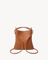The Embellie Mini in Cognac, worn as a backpack: the cords pulled through the loops as shoulder straps