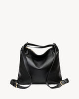 The Jusant in Noir, worn as a backpack: the strap fastened with gold buckles as two shoulder straps