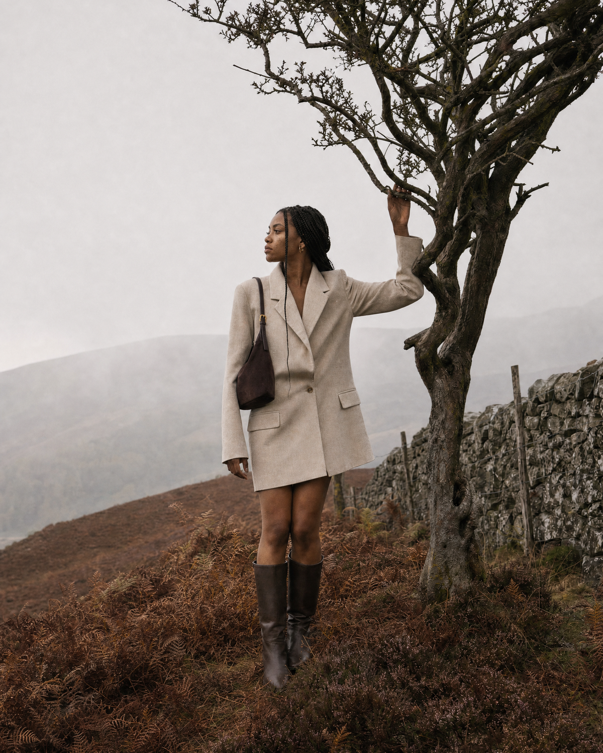 Woman under a lone tree on a misty moor with The Brume Petite in Chocolate