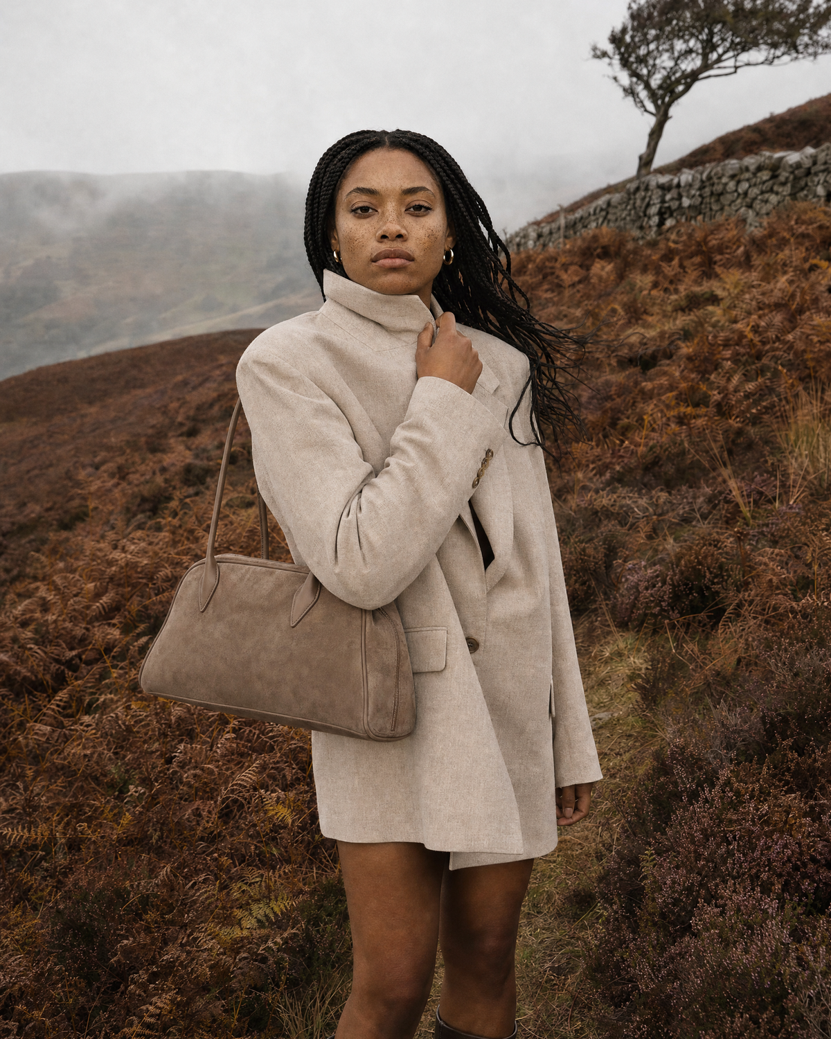 Woman in the wind on a misty moor with The Brume East-West in Galet