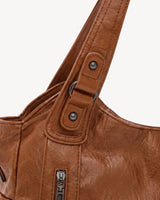 The Estran in Cognac, handle with riveted tab and gunmetal ring