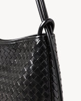 The Embellie Mini in Noir, close-up of the leather ring-loop and round cord handle