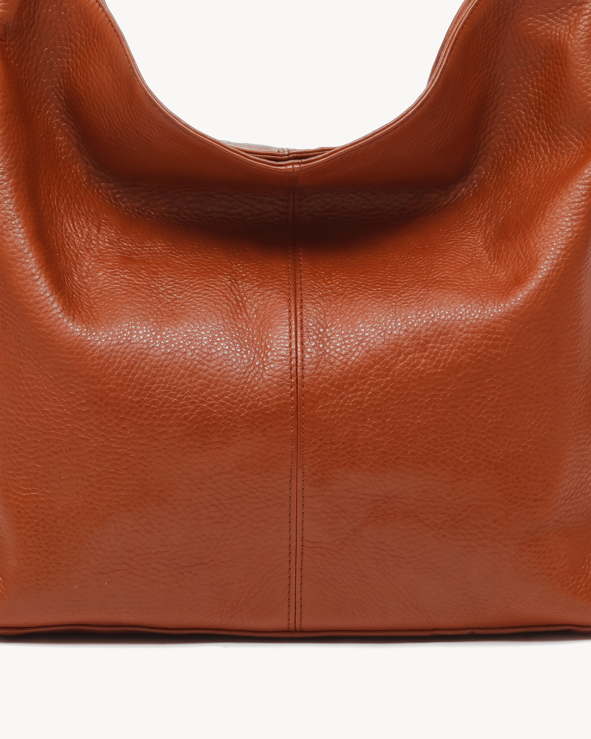 The Houle Soft in Cognac, close-up of the pebbled cognac brown leather and centre seam