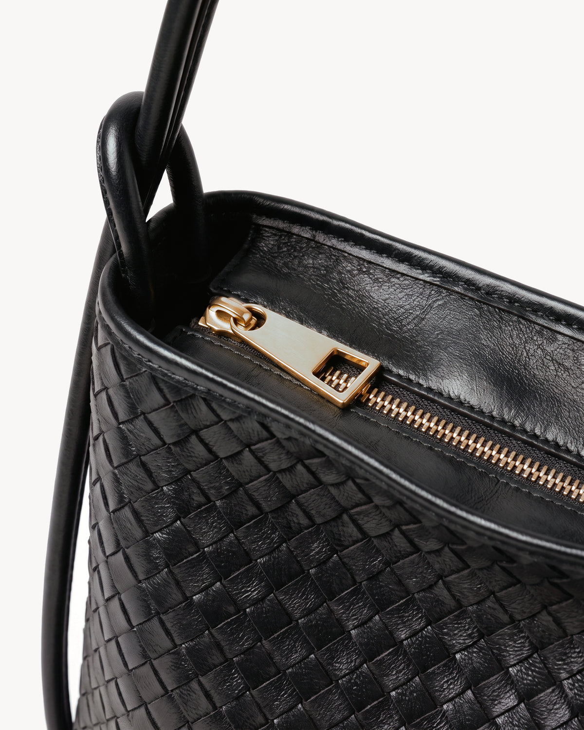 The Embellie Mini in Noir, close-up of the top zip closure