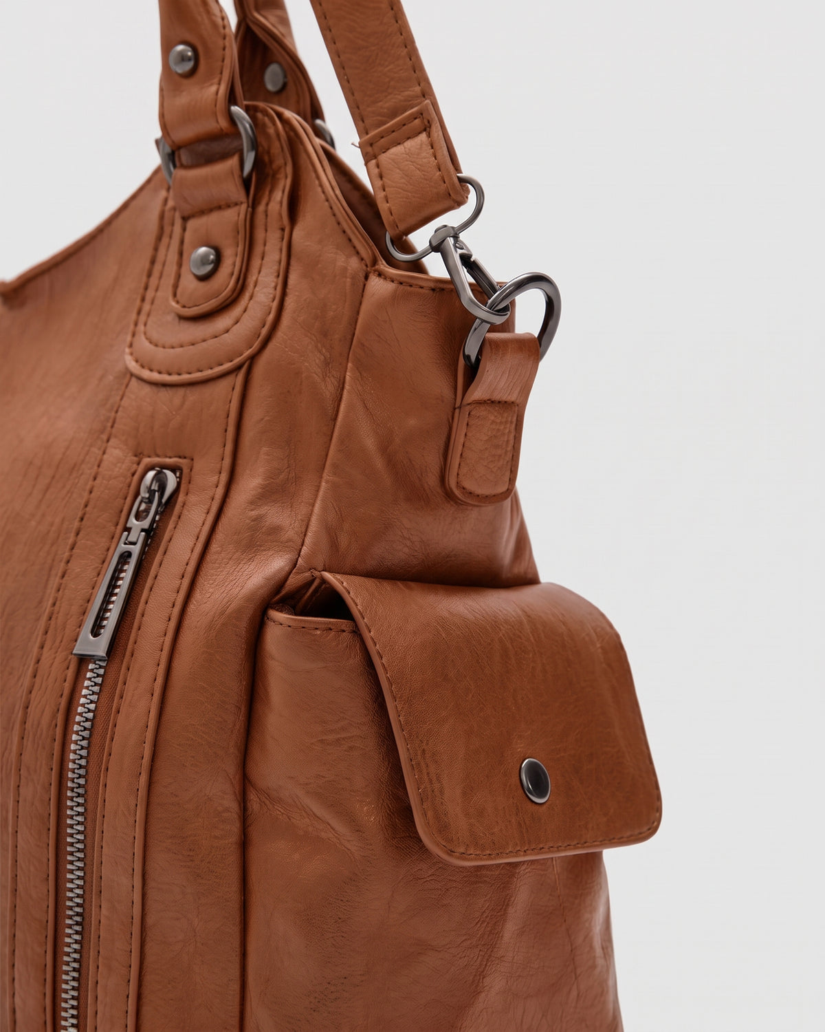 The Estran in Cognac, side snap pocket and strap ring